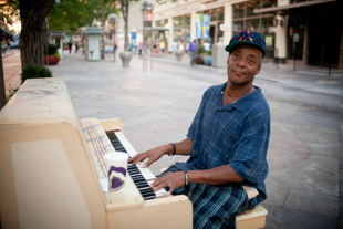 Dedrick Carpenter plays the piano on 16th street in downtown Denver CO.  
Dedrick, age 46, says he plays fairly often because he can make a few dollars.