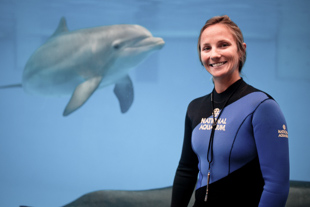 Keri Barton is a marine mammal trainer at the National Aquarium in Baltimore, MD.  She has always liked working with animals and likes how this also allows her to teach about conservation and the environment.