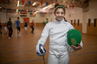 Huda Aldadah likes sports and her favorite sport is fencing.
  She has been practicing and training at Peoria Fencing Academy since she was a 2nd grader 
(she is now in 7th grade). ‘It takes a lot of practice and focus’, she said, ‘I like it because it is not ordinary’.