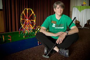 Ann Schmitt is the Curator of Education at Lakeview Museum in Peoria. 
 Working at the museum is 'like going to college forever... you never stop learning'. 
She is posing with the K’NEX miniature golf hole she helped to build for the ‘Fore the Fun of It' event at the Museum.