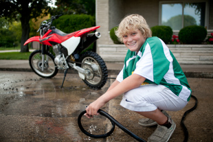 Andrew Runkle of Peoria is cleaning his dirt bike after riding at Espy Park in Pekin. 
It was muddy today because of the rain this week. The 8th grader said he rides for fun but will race at the park sometimes.