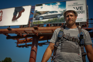 Jeff Taylor of Peoria likes hanging signs for Adams Outdoor Advertising and says it’s a good place to work.
 He said it takes about an hour to hang 3 signs.