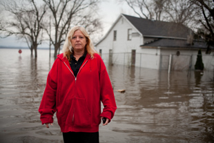 Kim Schilling of Spring Bay Illinois has 3 feet of water in her home from the Illinois River. She is worried about what damages the insurance will cover. ‘People keep asking me if I want to move’, she said, ‘this is my home, I just want to come back’.