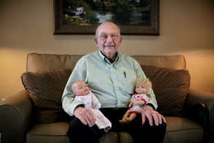 Roy Roth lives at The Apostolic Christian Home of Eureka, he is being visited by his grandchildren
 (who asked him to hold their dolls). ‘They are busy with their life, I am thankful when they have time to visit’, he said. 
 He said he operated an 18 wheeler for 58 years and is now 87.