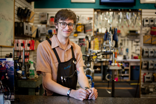 Chris Wheeler is a bicycle mechanic at Bushwacker in Peoria. He likes to ride also, going on long distance rides 
and bicycle tours. Working on his own bike got him interested in doing it as a job.